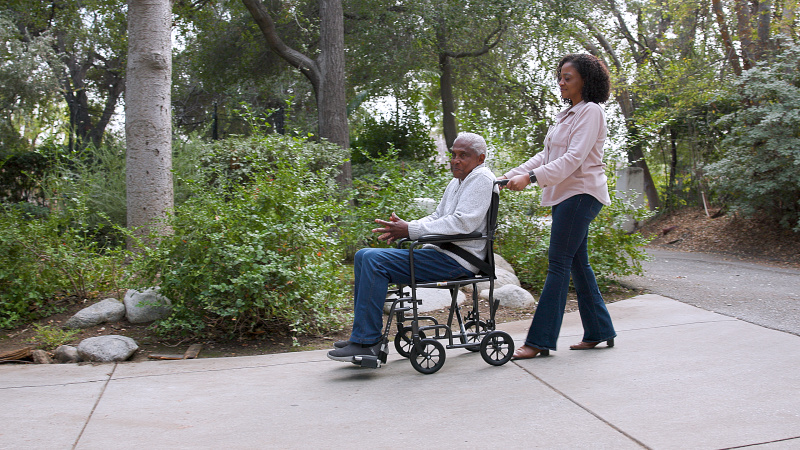 Person being pushed in a Transport Wheelchair